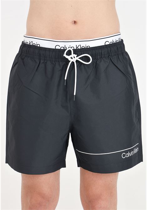 Shorts mare nero da uomo con stampa logo ed elastico in vita logato CALVIN KLEIN | KM0KM00957BEH